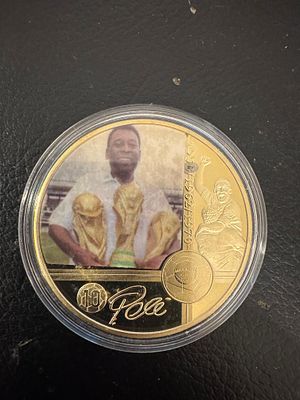 Pel&eacute; – Gold-Tone Collectible Fantasy Coin – Three-Time World Champion. A gold-tone fantasy coin 