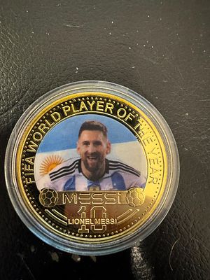 Lionel Messi – Gold-Tone World Champion Souvenir Coin. A collectible fantasy coin dedicated to 