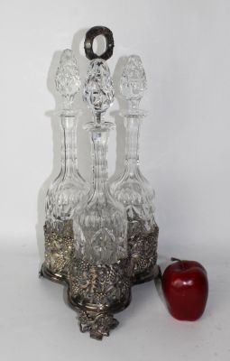 Crystal decanter set in silverplate caddy with relief grape vine motif. 20th century. 18"h x 10"w