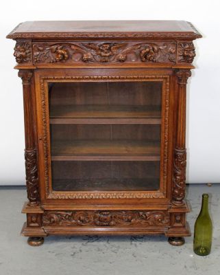 French carved oak single door bookcase with relief lion heads. Late 19th century. 39"h x 31 