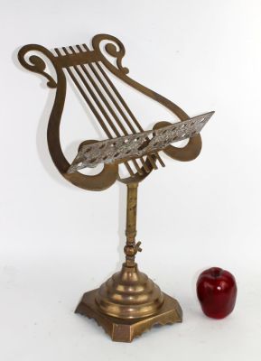 Adjustable lyre shaped footed music stand in brass. 20 1/4"h x 13'w x 10"d