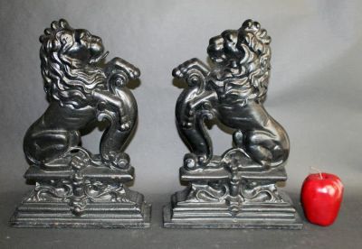 Pair of black painted cast iron lion chenets. Early 20th century. 14"h x 10 1/4"w x 2 3/8"d
