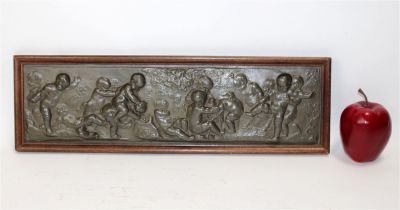 Belgian bas relief plaque depicting cherubs in wood frame. Artist signed. Early 20th century. 