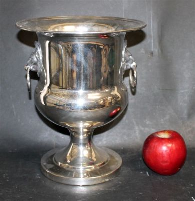 Silverplate champagne bucket with lion head ring pulls. 10 5/8"h x 8 3/4"dia