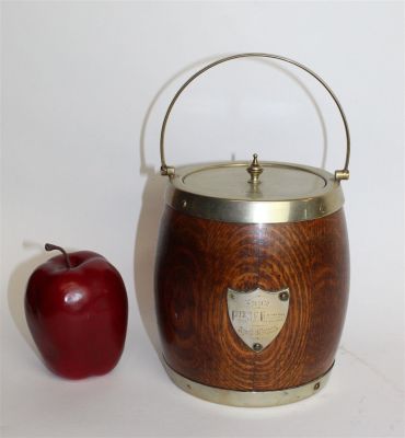 English oak biscuit barrel. Antique English oak biscuit barrel with shield crest dated 1915. 