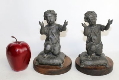 Pair of figural bookends, cherubs kneeling on pillows. Pair of figural metal bookends, cherubs 