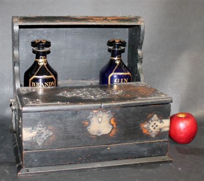 Antique English tantalus set in oak with metal overlay. With 2 cobalt liquor bottles. Case 12 