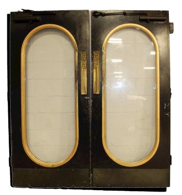 Pair of entry doors with oval glass panels. Art Nouveau brass push plates. From Olde Blind Dog 