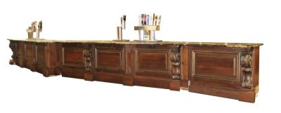 33' long Front bar in carved walnut & pine with marble top. 33' long Front bar from Bar at Olde 