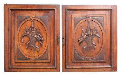 Pair of French walnut panels with relief carved flowering baskets. Early 20th century. 25 1/2"h 