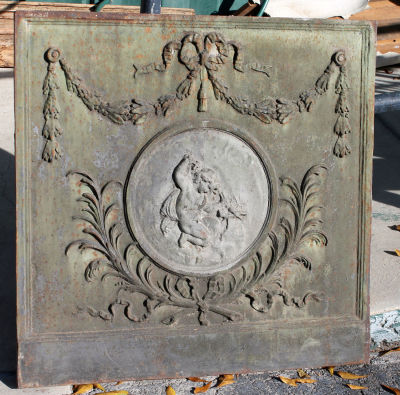 Antique French cast iron fireback with cherub. 19th century. 34 1/2"h x 35 1/4"w