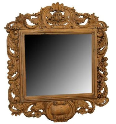 Carved oak mirror with cherub mask and foliate carvings. Carved oak beveled mirror with cherub 