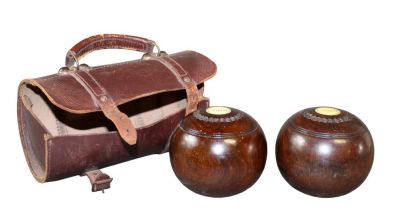 Antique English lawn bowling balls in leather sack. Antique English lawn bowling balls with 