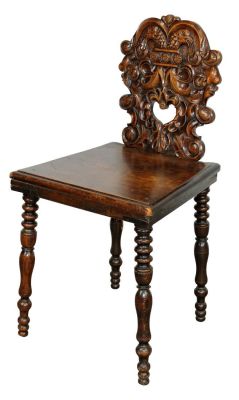 French relief carved hall chair in walnut with center cut out heart. Late 19th century. 33"h x 