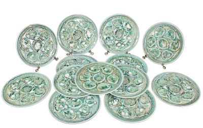 Lot of 13 French Niderviller pottery oyster plates. Mid 20th century. 10" diam