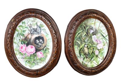 Pair French painted porcelain oval plaques painted with birds and flowers. In carved oak 
