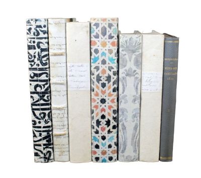 Set of 7 papier mache covered decorative books 9 1/2" h x 6 1/4" w --- 8 3/8" h x 5 3/4" w