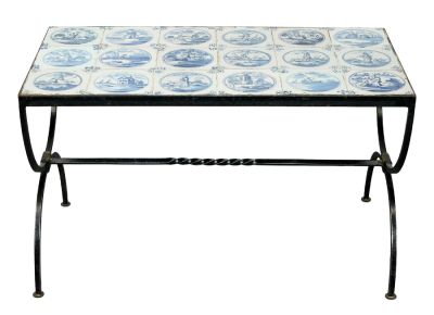 Iron curule base coffee table with Delft tile top. Iron curule base coffee table with antique 