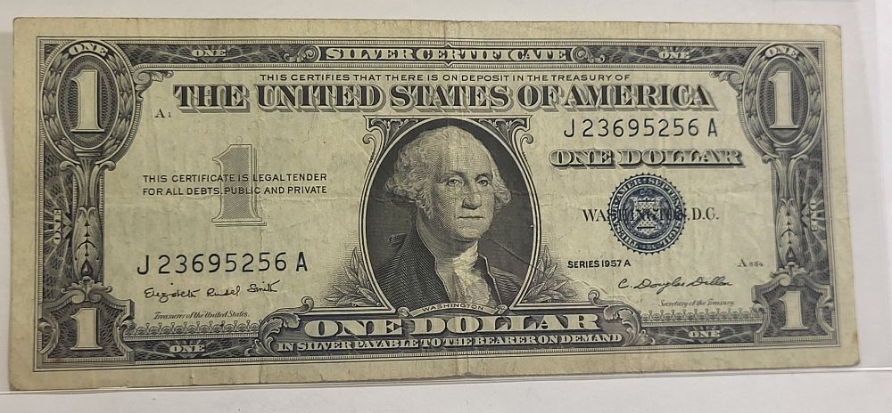 1957A silver cert dollar bill currency blue seal. check out the pics you decide the grade