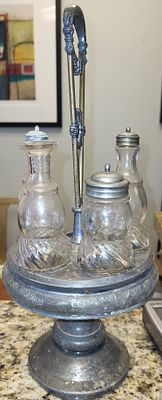 antique silver plated cruet set castor w/4 bottles. stands 16" , no cracks in the bottles a 