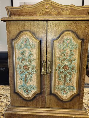 vintage style jewelry armoire w/4 drawers. it feature a distressed painted finish with floral 