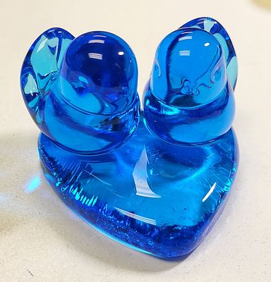 blue hand blown glass lovebird by Leo Ward. sitting on a heart base hand blown and signed eo 
