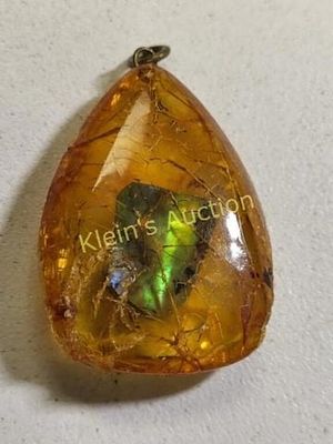 rare ammolite gemstone pendant in amber. check out the colors in this! 1 1/2" long x 1" wide 