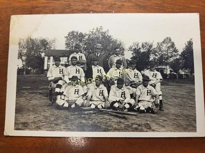vtg baseball team post card 1910-20's. the individual wearing striped sock and uniforms with a 
