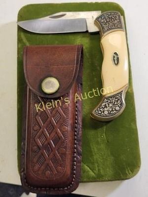 folding lock blade pocket knife w/leather sheath. very nice vintage knife blade looks new and 