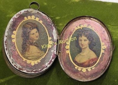 Tin locket Victorian hand painted! unusual piece. 2 1/2" by 2" when opens has pictures of girls 