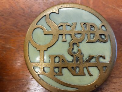 antique English brass suds & cuff links box. the light green background is an enamel inlay or a 