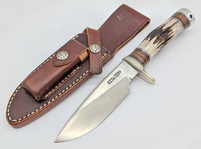 Randall Model 25 5in Stag Trapper w/ Sheath. Features a stainless steel blade with thumb notches 