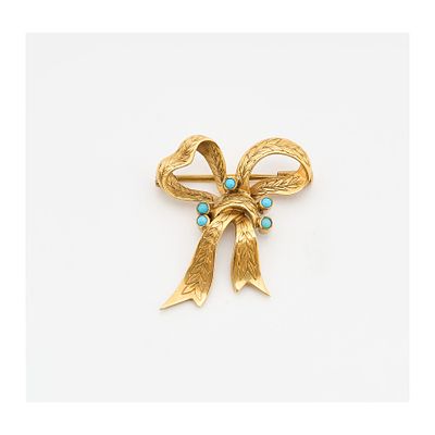 Broche diseño lazo en oro con labrado vegetal y cabujones de símiles de turquesa de 1,5 mm. 3 x 
