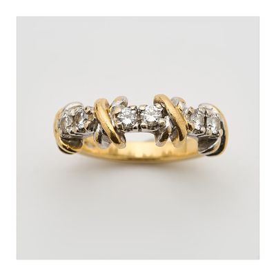 Sortija en oro bicolor con parejas de diamantes talla brillante y motivos diseño cruzado 