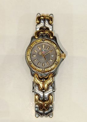 TAG Heuer professional 200 meter watch in steel and plated with calendar