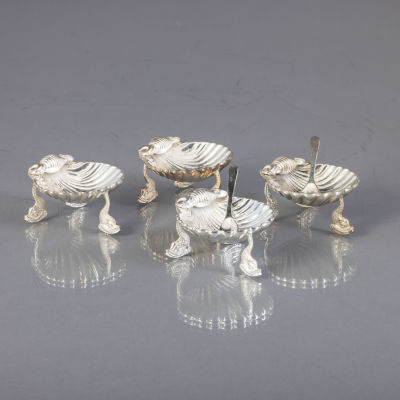 QUATRO SALEIROS "CONCHA". Em casquinha, decora&ccedil;&atilde;o relevada, p&eacute;s na forma "golfinho" 