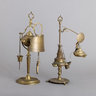 DUAS CANDEIAS DE AZEITE. Em metal amarelo, com quebra-luz e diversos utens&iacute;lios, bases de 