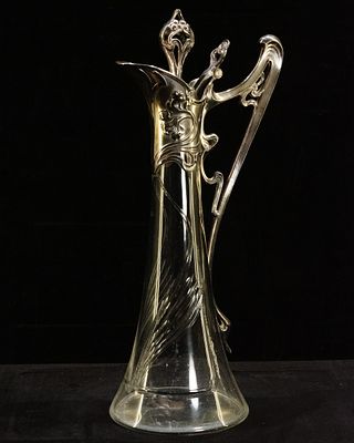 Art Nouveau Jug. Art Nouveau glass jug with hinged lid and pewter handle.Dimensions: 38 cm