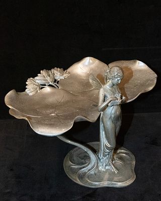 Art Nouveau business card tray. Tin business card tray with winged female figure caressing a 