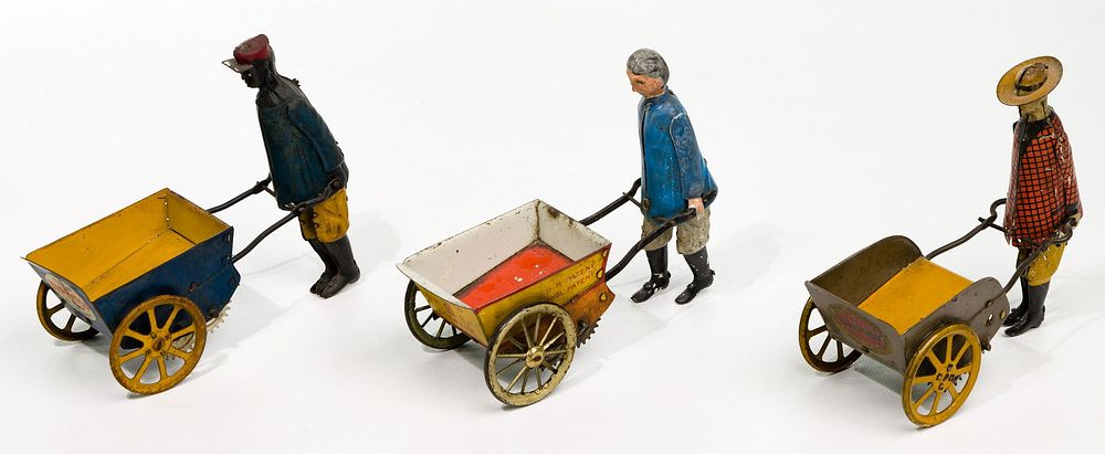 Lot 443: Wheelbarrow Tin Toy Assortment
