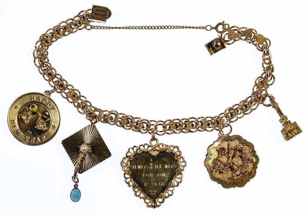 Lot 312: 14k Gold Charms on a Gold Filled Bracelet