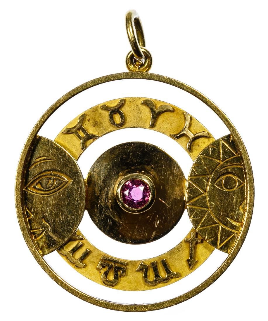 Lot 461: Gubelin 18k Gold and Ruby 'Zodiac' Pendant