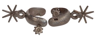 Mexican Spurs Having Silver Overlay A pair of steel spurs having engraved delineation of silver 