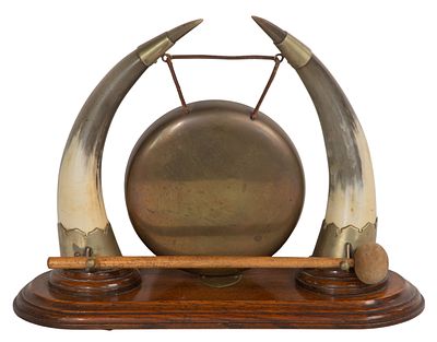 Anglo-Burmese Two-Horn Dinner Gong Having a brass gong suspended from two brass mounted water 