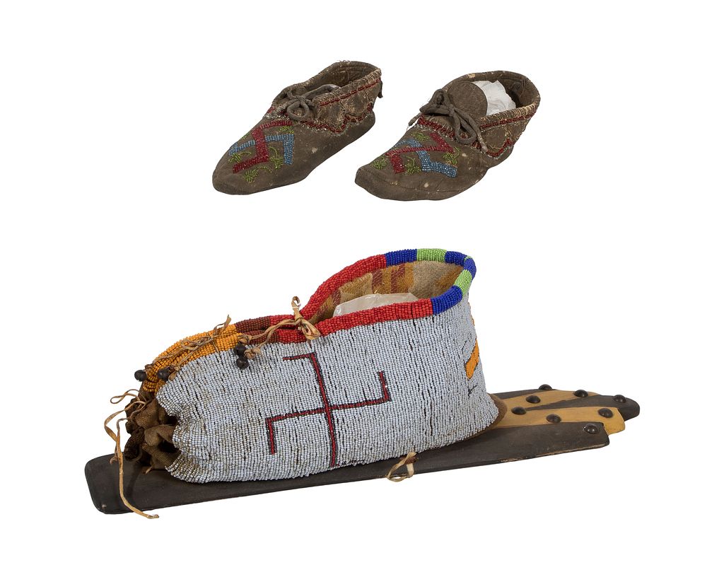 Lot 680: Native American Whirling Log Toy Cradleboard and Moccasins