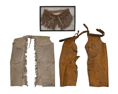 Leather Chaps (3) total items including a pair of chaps having a tooled belt, a pair of chaps 
