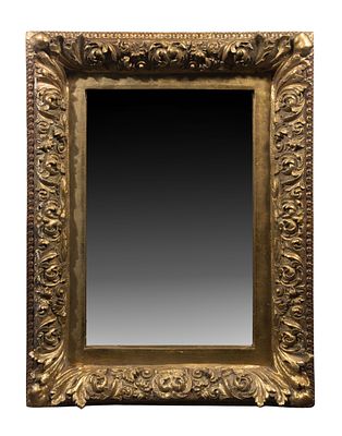 Baroque Style Mirror Having a gold-tone gesso on carved wood frame Property from: an Estate 