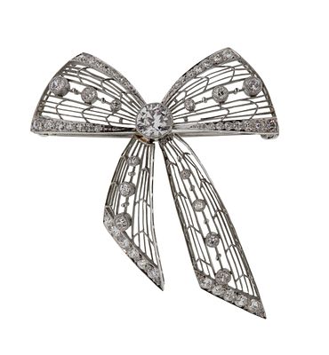 Platinum and Diamond Bow Brooch An open weave setting, articulated tails having a center round 