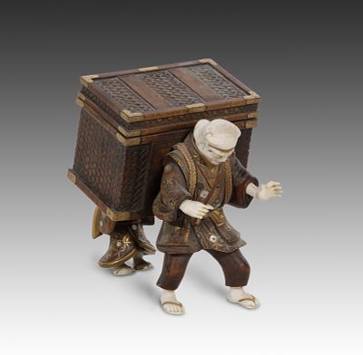 Japanese Wood and Chryselephantine Box An okimono depiction of two figures carrying a 