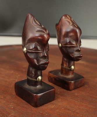 Pair Hagenauer Style Ethnographic Busts. Carved wood, brass details. Stamped, Made in Haiti. 